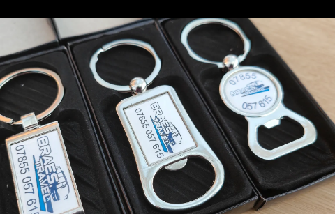 Boxed keyring and bottle-opener set branded for a travel company